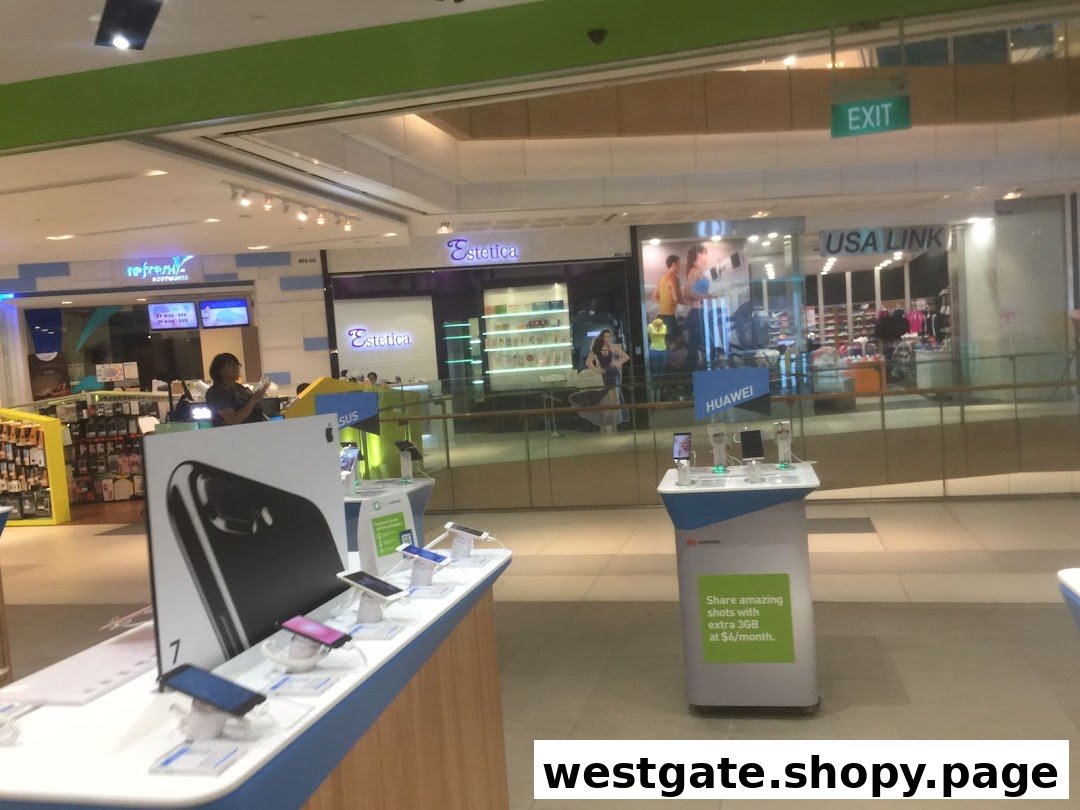 Interior view of a mall showcasing mobile phone displays and various retail shops.