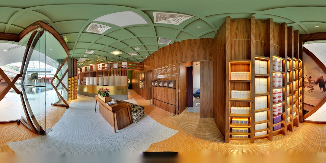 A panoramic view of Strip Co-Ed Westgate's modern interior with wood accents and product displays.