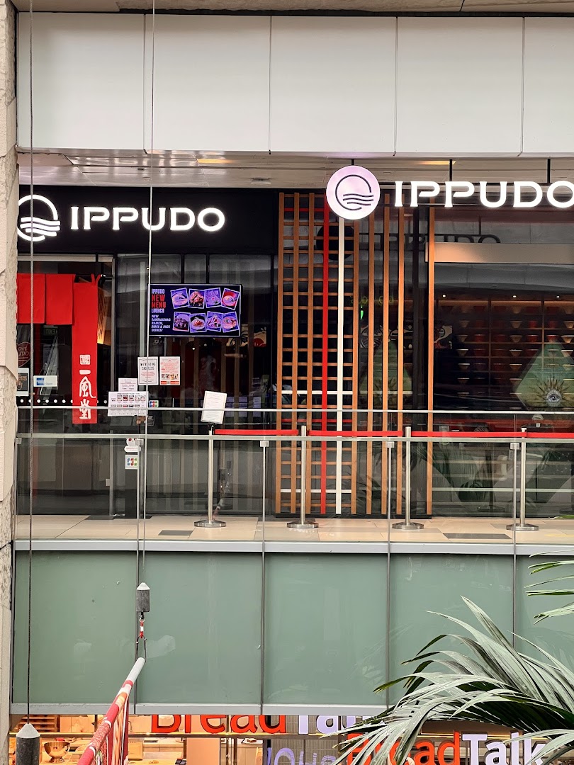 The shopfront of IPPUDO, a Japanese ramen restaurant, featuring its prominent logo and entrance.