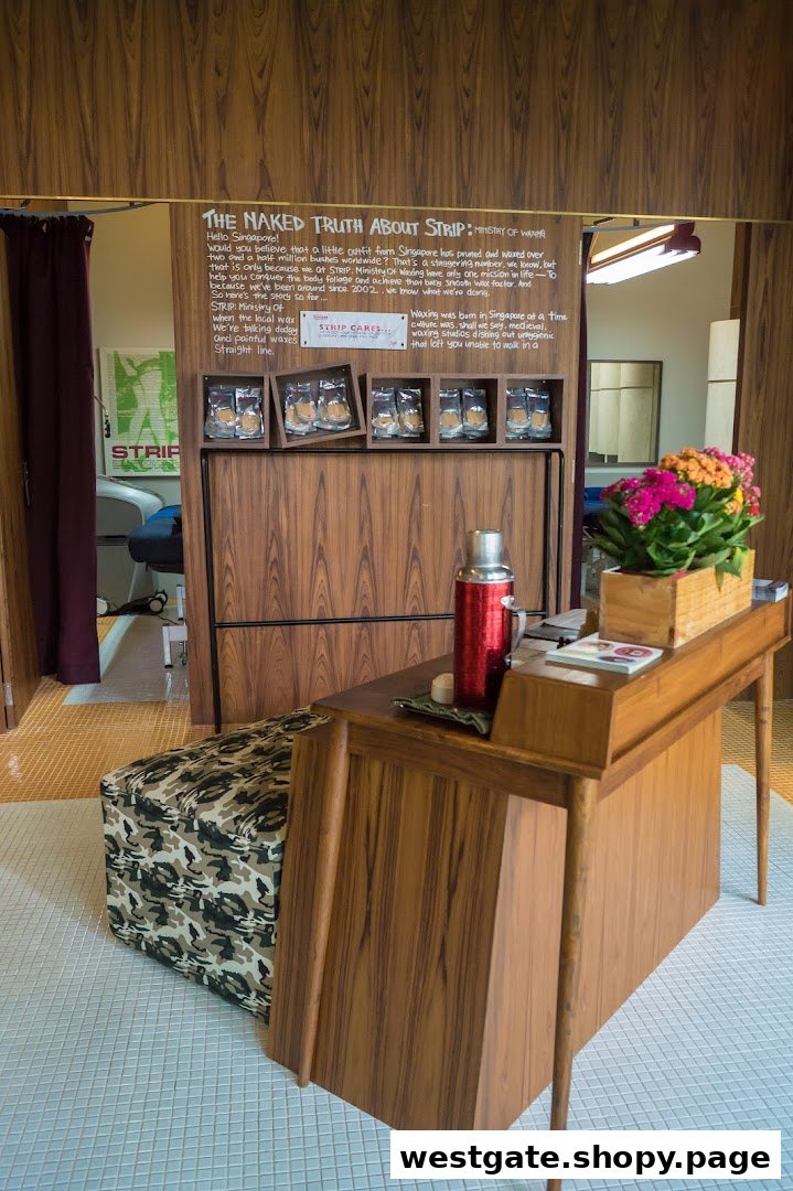 Interior view of Strip Co-Ed Westgate, featuring a reception desk, product display, and treatment room entrance.