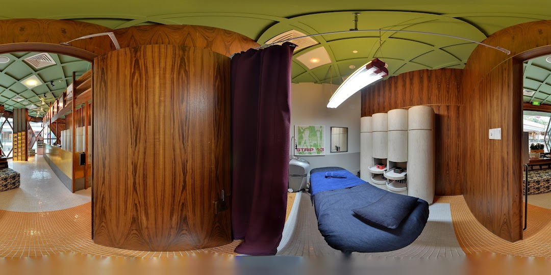 A modern and inviting interior of a beauty salon, featuring a treatment room and reception area.