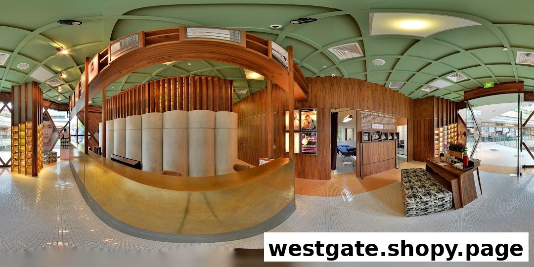 A panoramic view of Strip Co-Ed Westgate's modern interior, featuring a golden reception desk and treatment rooms.
