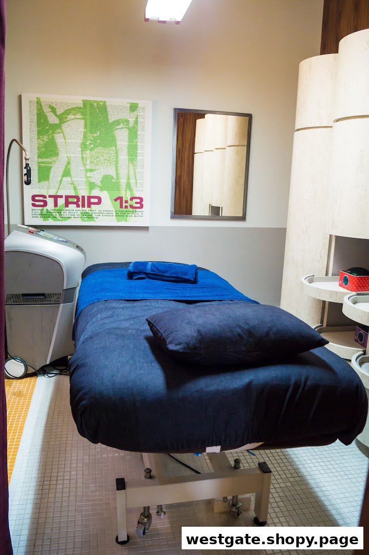 A comfortable treatment room at Strip Co-Ed Westgate, featuring a bed and specialized equipment.