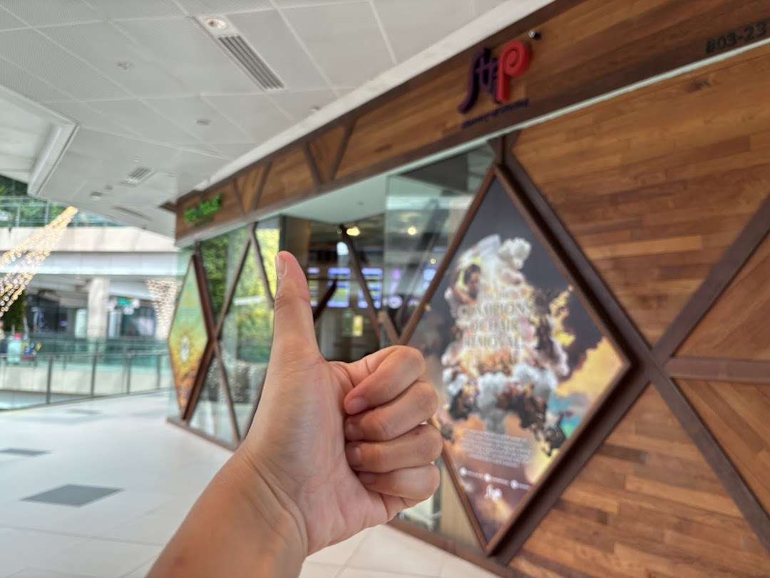 The exterior of Strip Co-Ed Westgate, a hair removal salon, with a thumbs-up gesture.