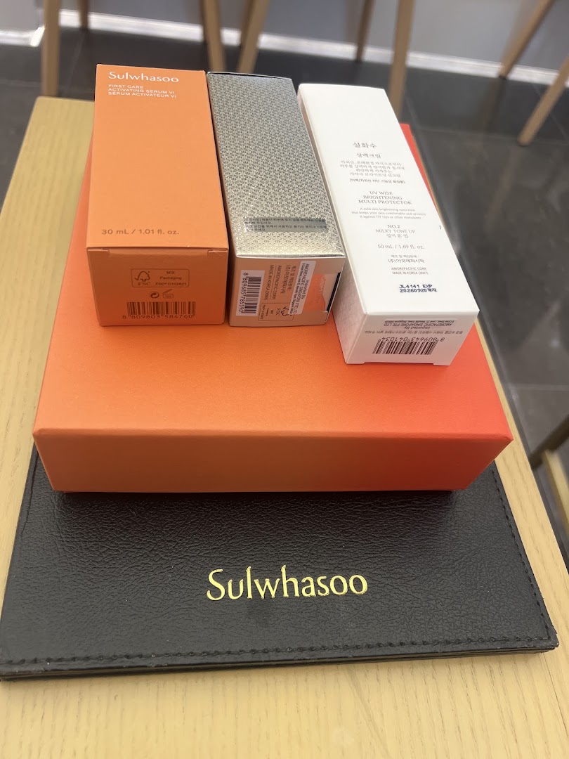 Close-up of Sulwhasoo skincare product boxes and a branded mat, showcasing premium Korean beauty.
