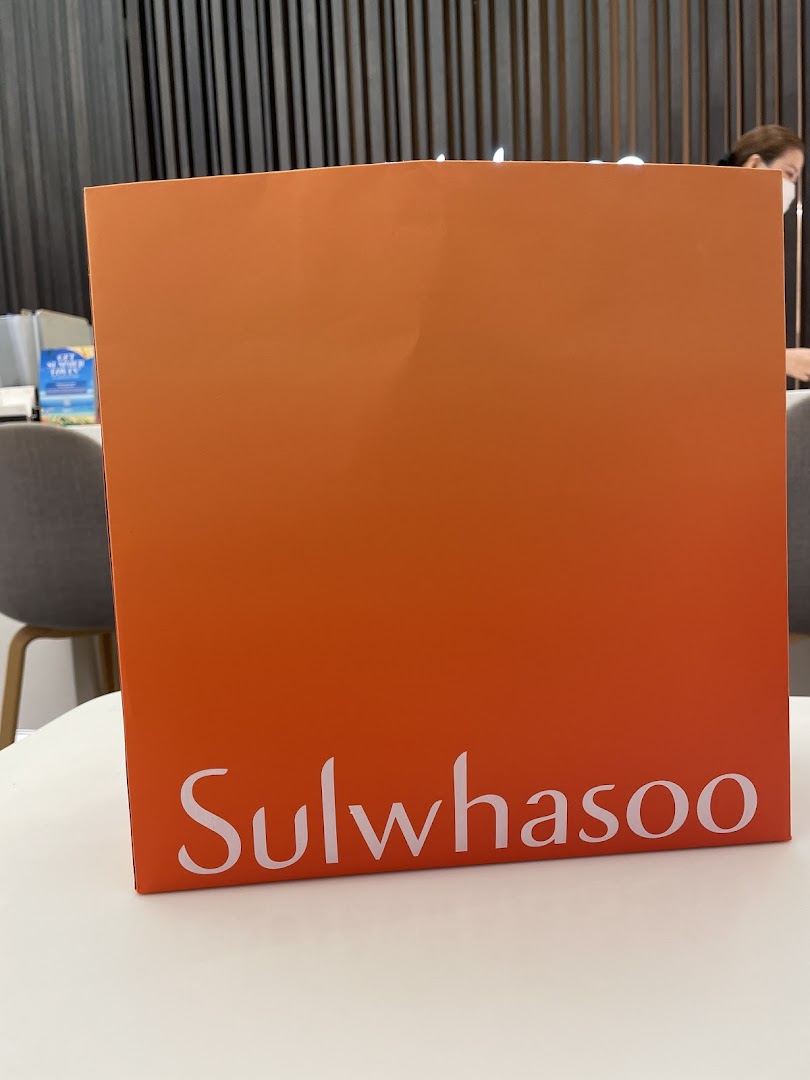 A Sulwhasoo branded item, likely a bag or display, on a white table inside the boutique.