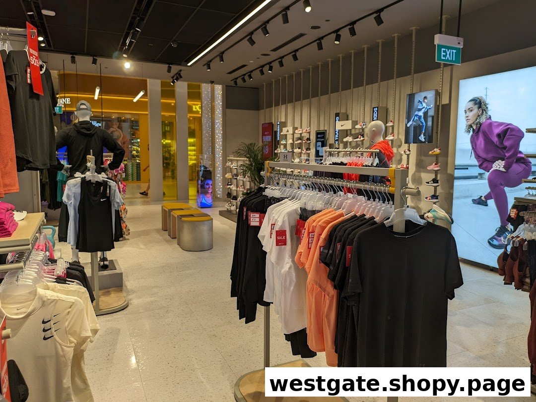 Interior view of Sun & Sand Sports, showcasing activewear, footwear displays, and mannequins in a brightly lit space.