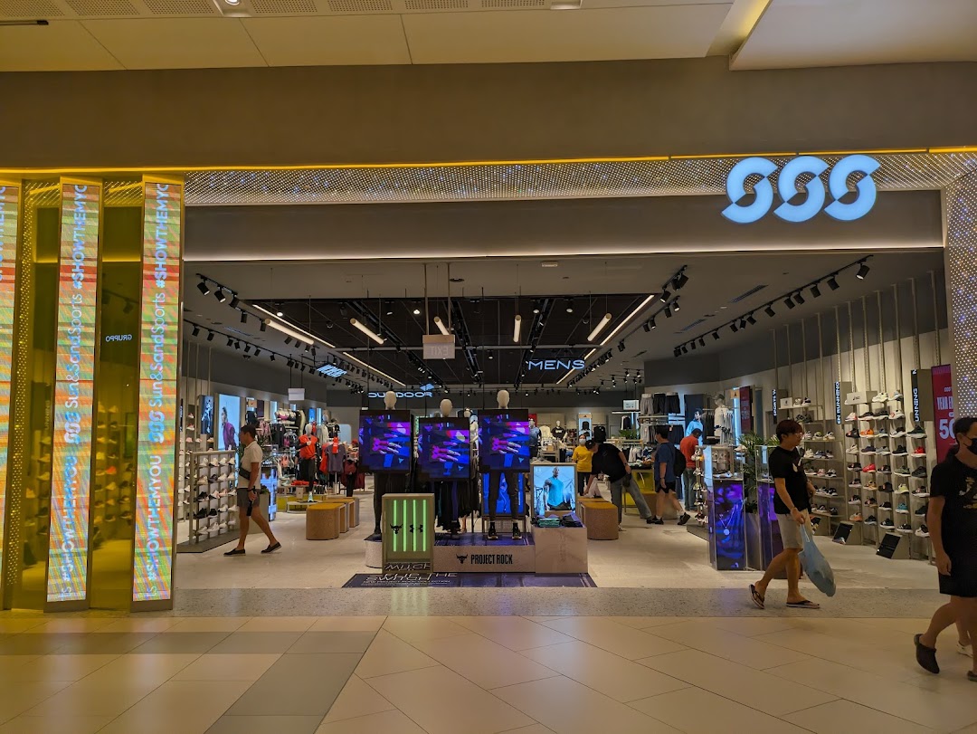The brightly lit entrance of Sun & Sand Sports, showcasing athletic apparel and footwear.