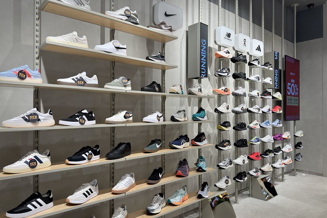 An interior view of Sun & Sand Sports showcasing a wide array of athletic and casual footwear on display.