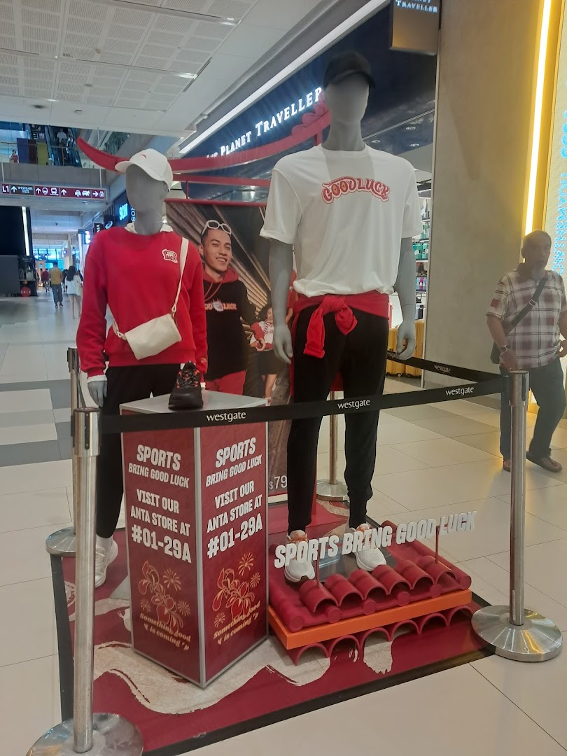 Sun Sand Sports showcases Anta sportswear with 'Sports Bring Good Luck' theme on mannequins.