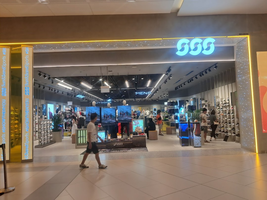 The brightly lit entrance of Sun & Sand Sports, showcasing a wide range of athletic wear and footwear.