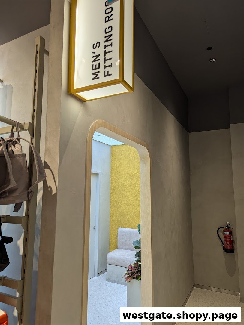 Interior view of Sun Sand Sports, highlighting the men's fitting room entrance with a clear sign.