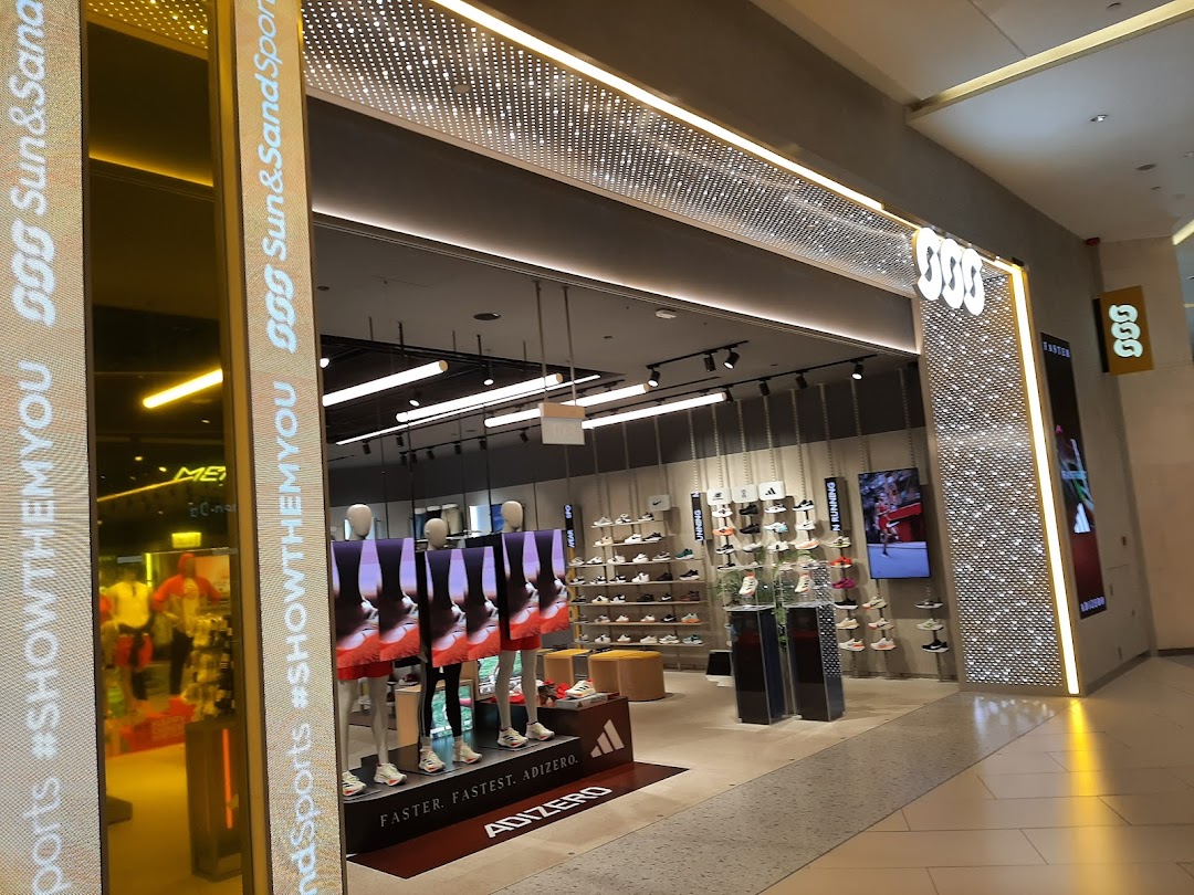 The brightly lit entrance of Sun & Sand Sports showcasing athletic footwear and apparel displays.