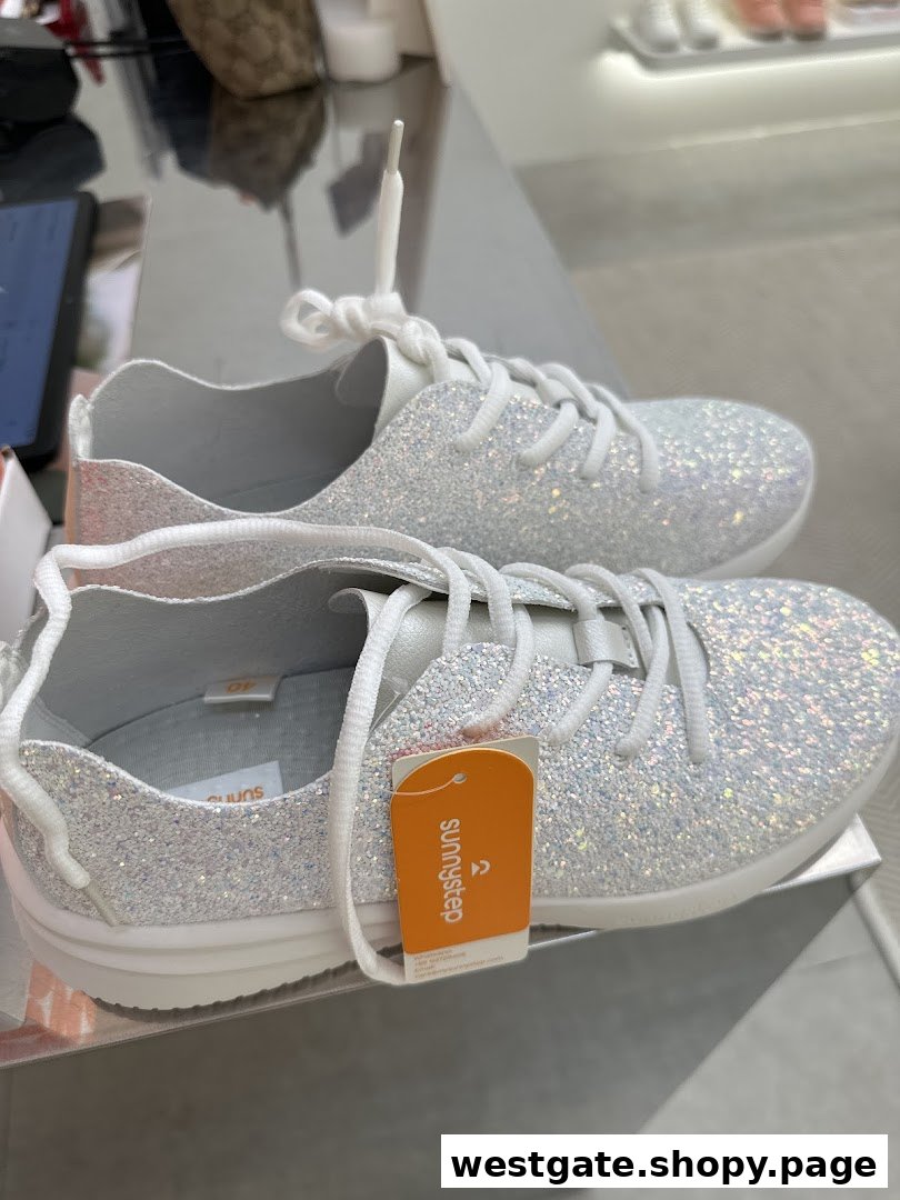 A close-up of a pair of sparkling white Sunnystep sneakers with a product tag.