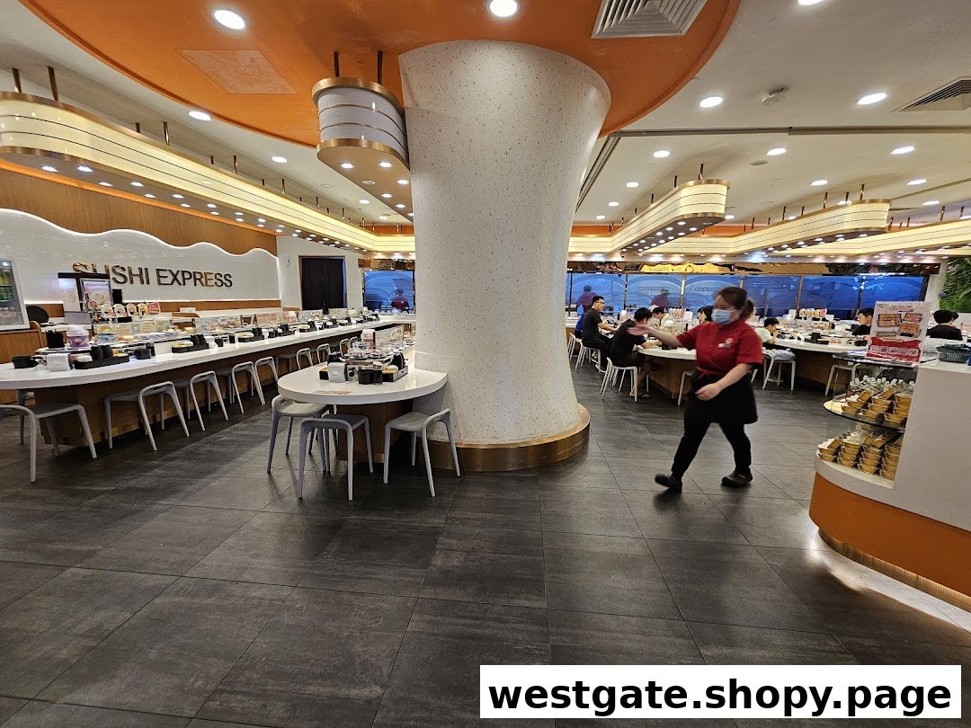 Interior view of Sushi Express, showcasing its conveyor belt sushi system and a staff member.