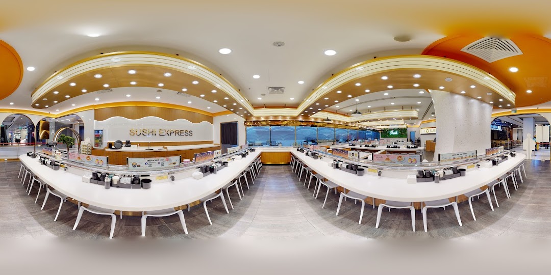 A panoramic view of the modern and spacious interior of Sushi Express, featuring its signature conveyor belt dining.