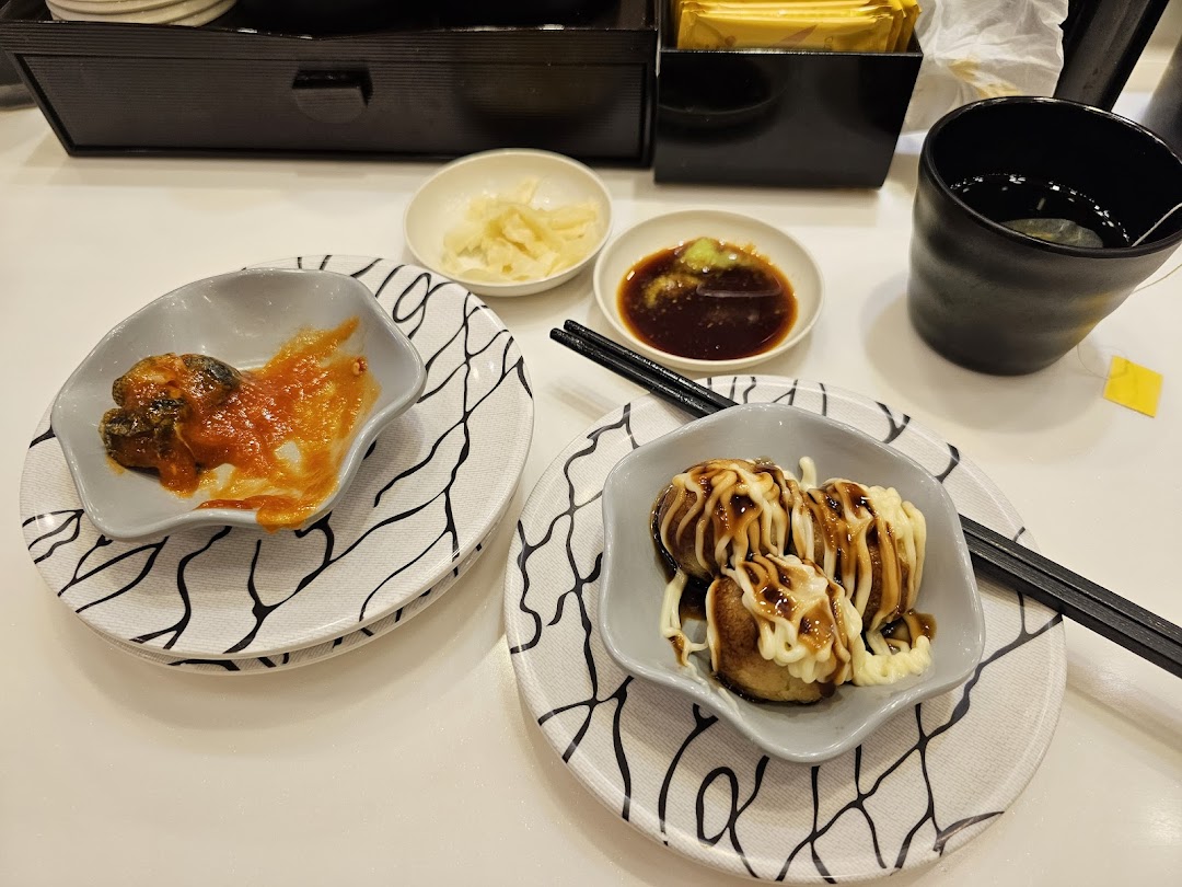 Close-up of delicious Japanese side dishes and tea served at Sushi Express.