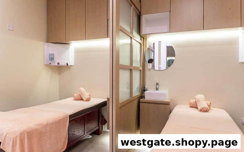 Two treatment beds in a clean, modern spa room with wooden accents and soft lighting.