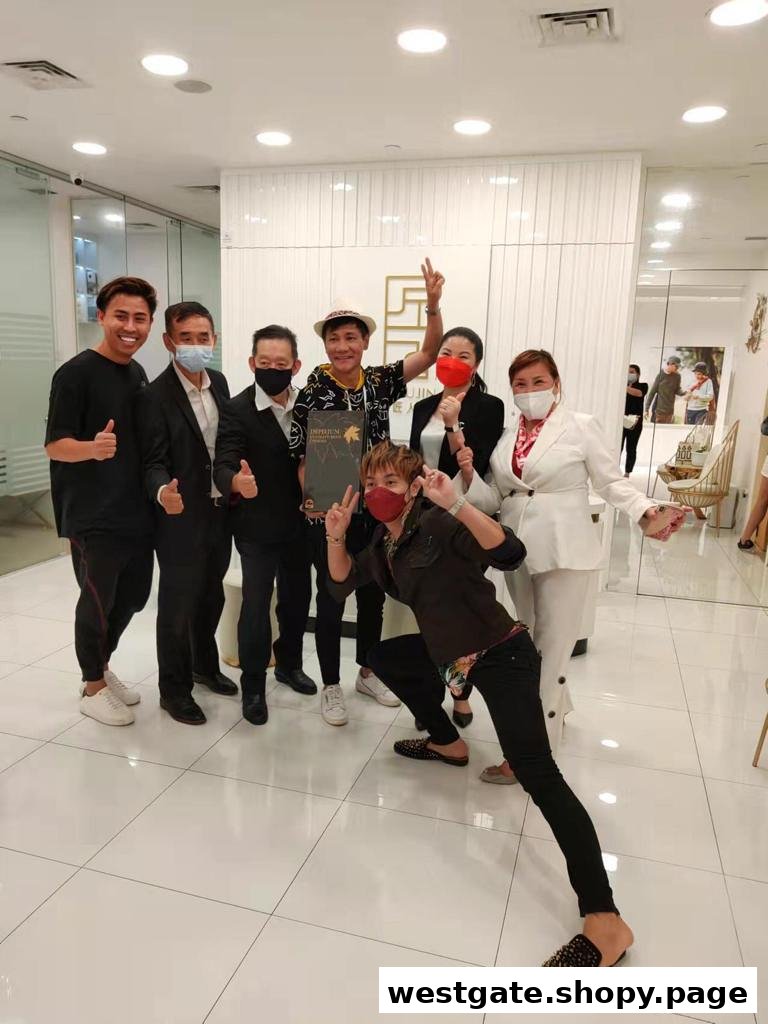 A cheerful group of staff and partners posing inside the bright Syoujin retail space.