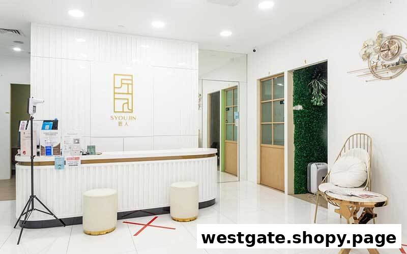 A bright, modern reception area with a white desk, gold accents, and Syoujin branding.