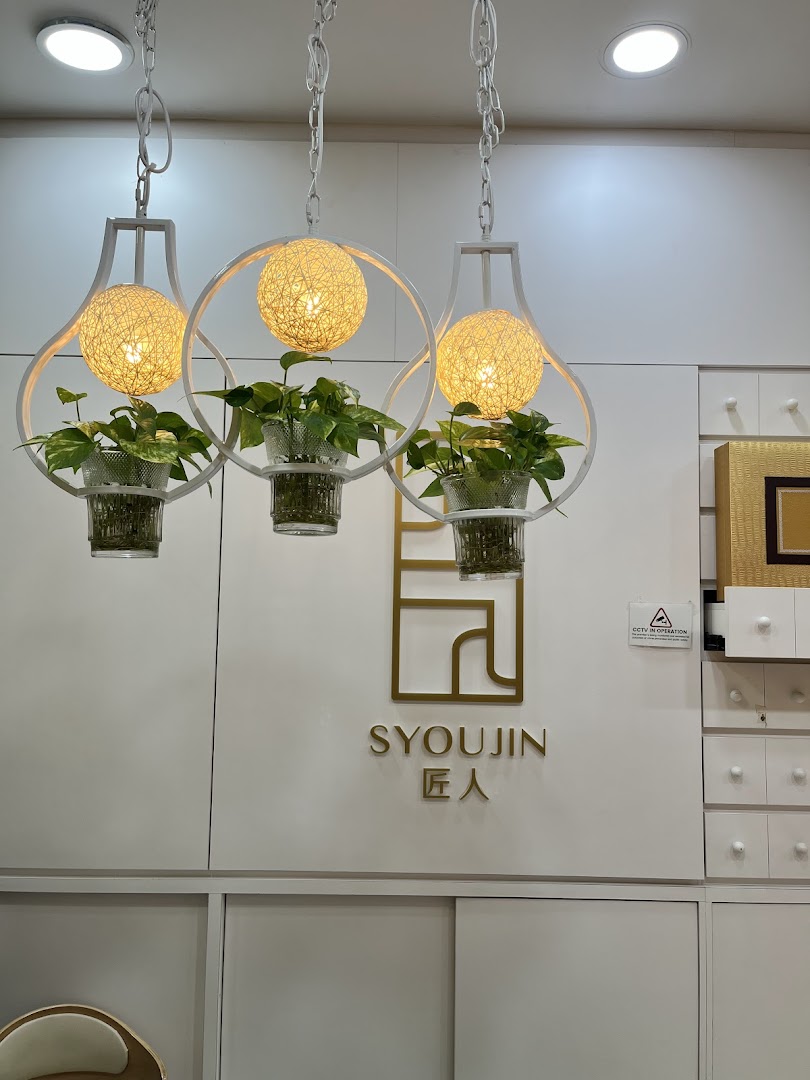 Interior view of Syoujin featuring decorative hanging lights with plants and the shop's logo.