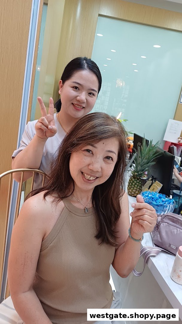 Two smiling women, one staff, one customer, posing happily inside a bright shop.