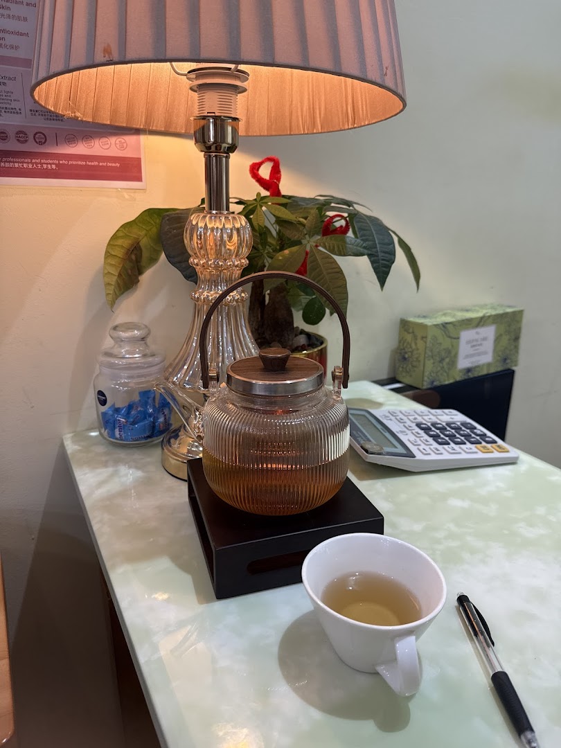 A cozy corner with a teapot, cup of tea, and lamp, suggesting a relaxing atmosphere.
