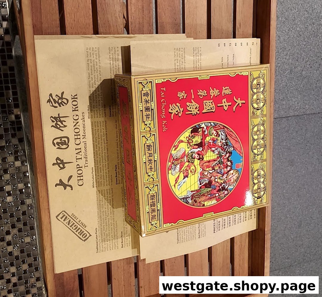 A display of traditional mooncake boxes and a brochure detailing various mooncake flavors and prices.