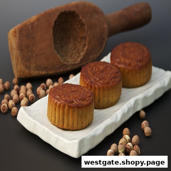 Three golden mooncakes on a white platter with lotus seeds and a traditional mold.