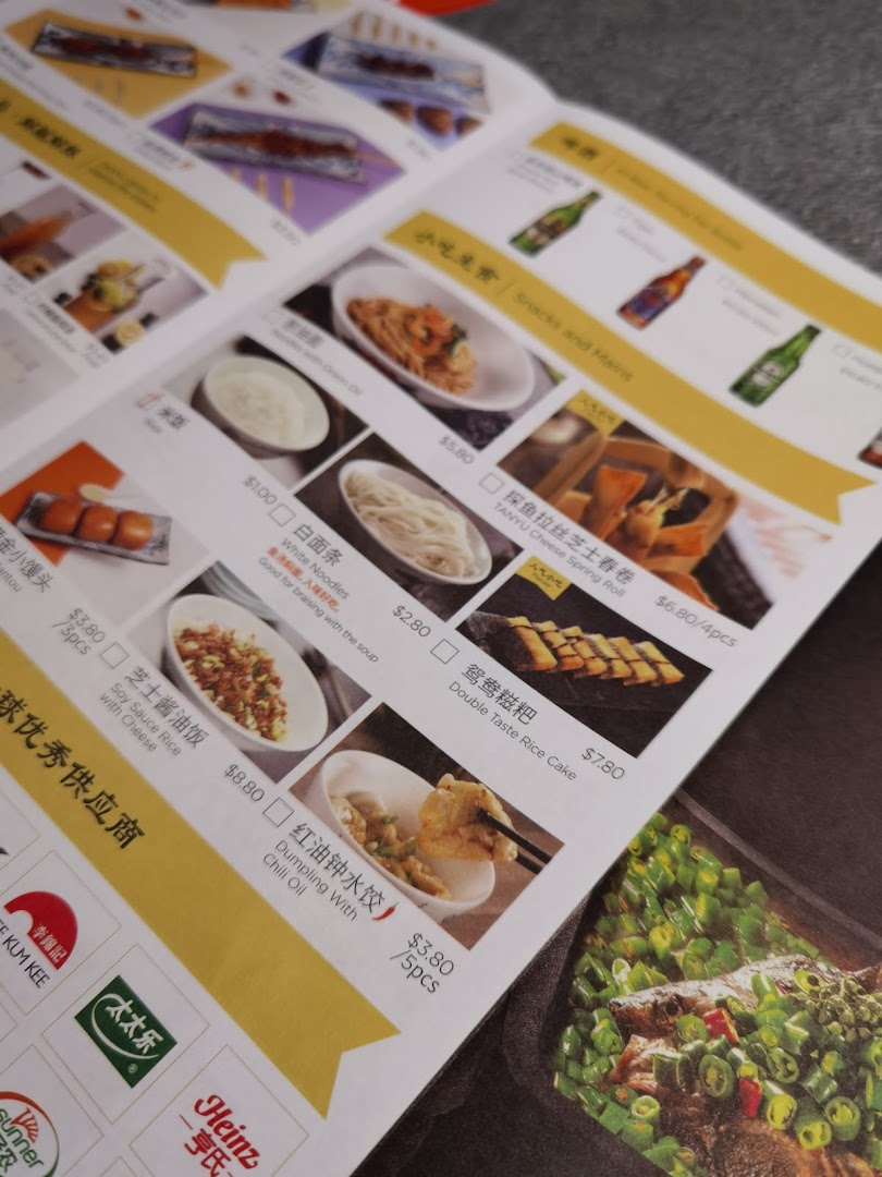 A close-up view of a menu page featuring various snacks and main dishes with prices.