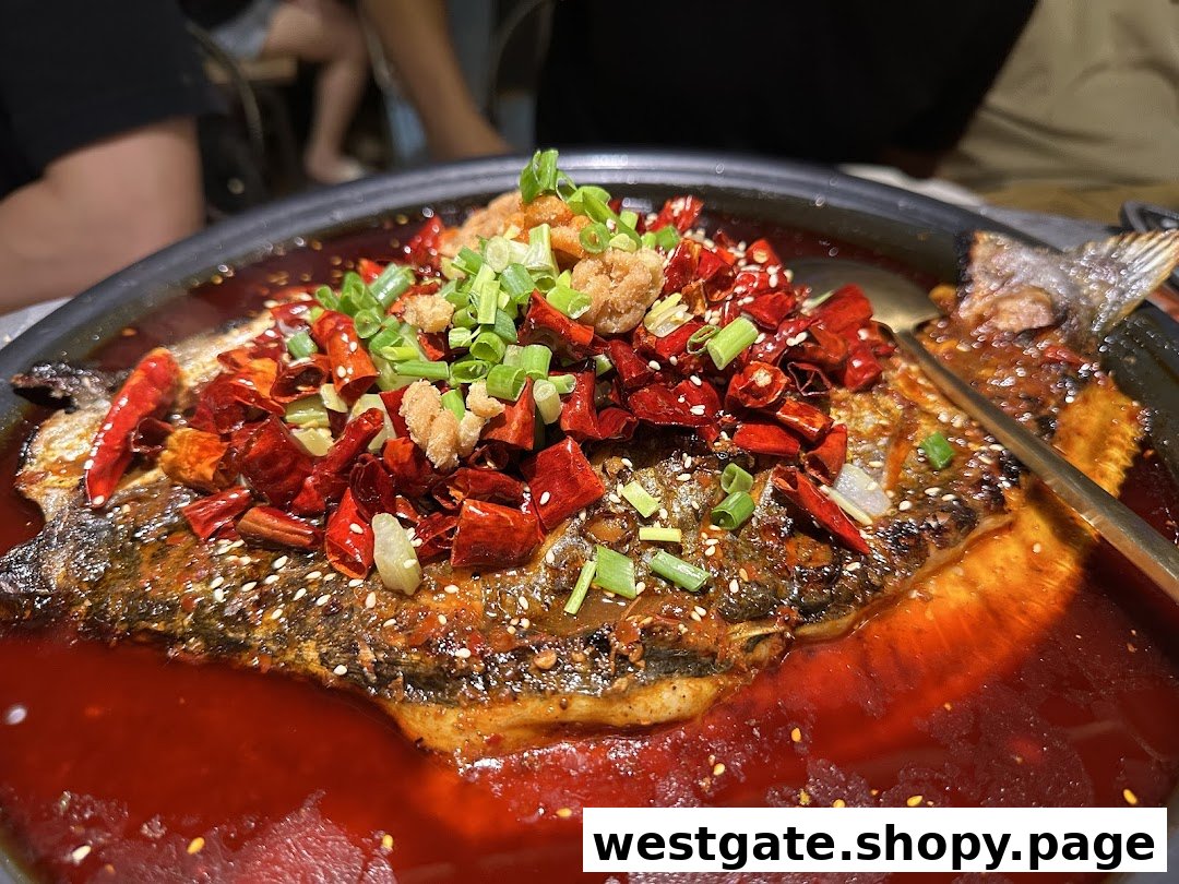 A vibrant, spicy whole fish dish, generously topped with chilies, green onions, and crispy bits in a rich red sauce.