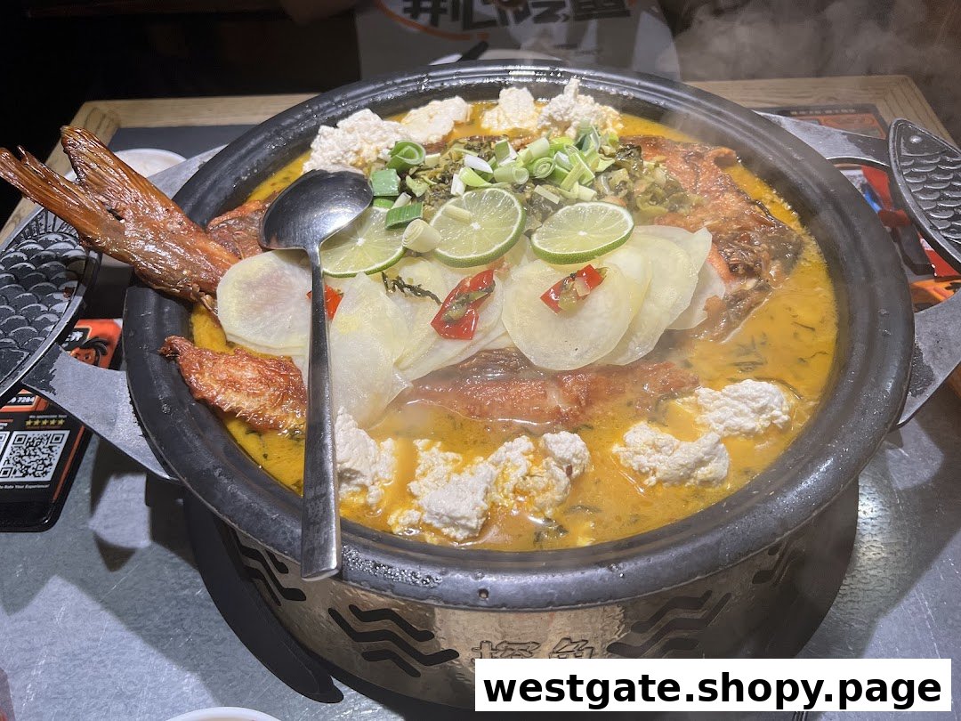 A large, steaming pot of grilled fish with lime, tofu, and vegetables, served on a table at TANYU.