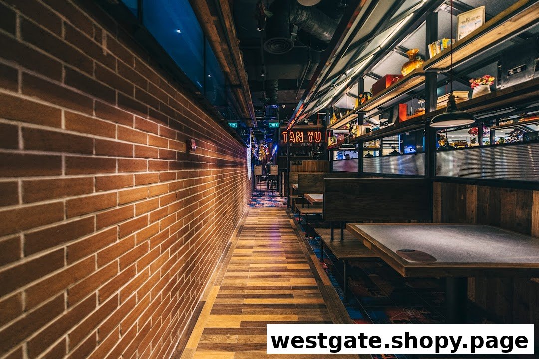 An interior view of TANYU Westgate, featuring a long brick wall, wooden flooring, and booth seating.