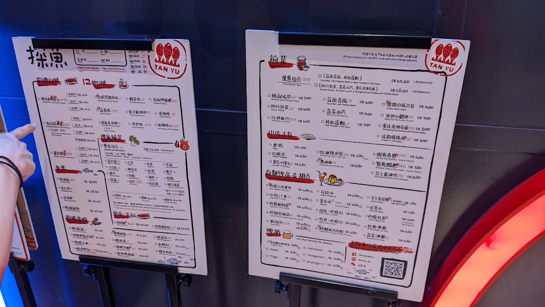 Two large menu boards displaying a variety of Chinese dishes and drinks.