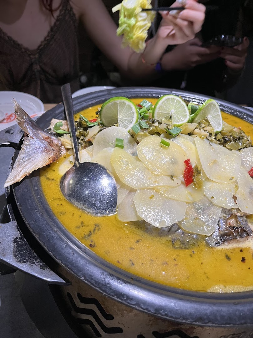 A large pot of TANYU's signature grilled fish with lime and potatoes, served hot at the table.
