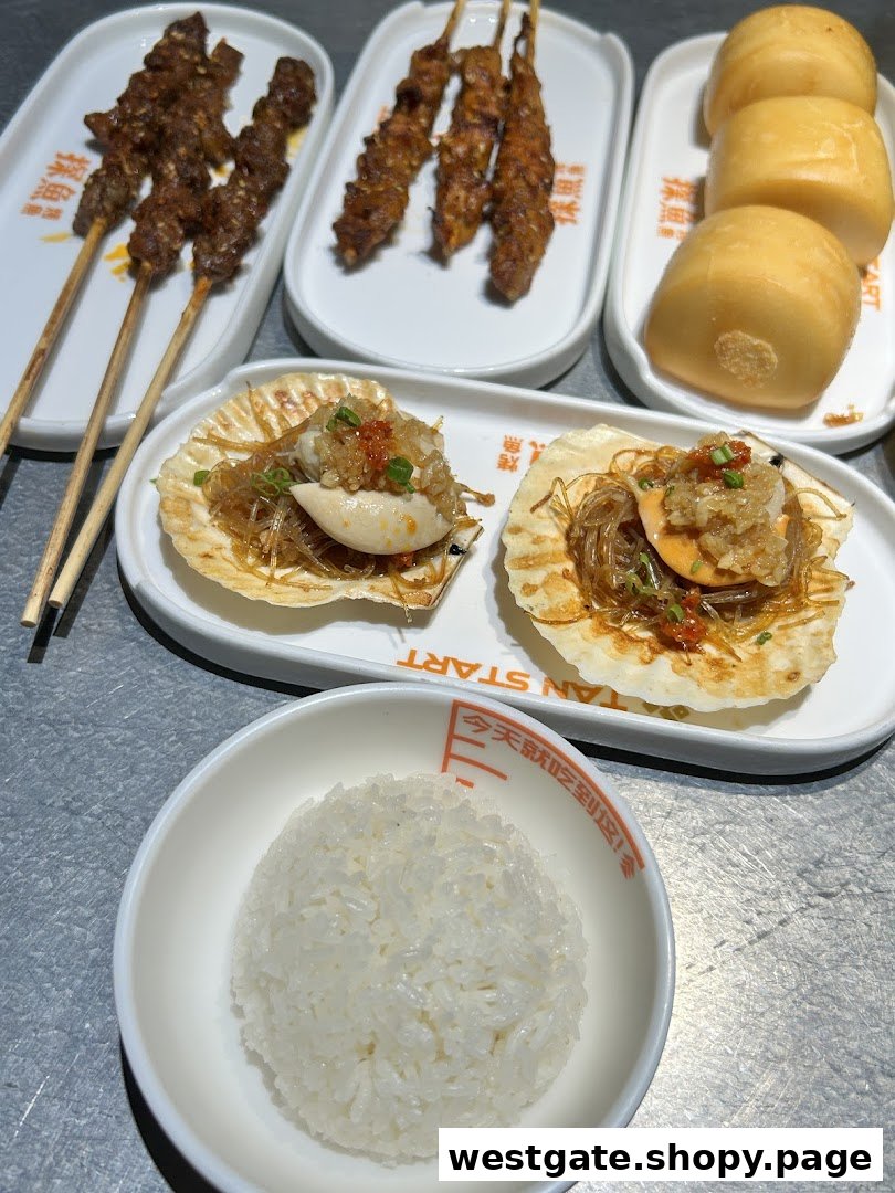 A close-up of various delicious dishes from TANYU, including grilled skewers, baked scallops, steamed buns, and white rice.