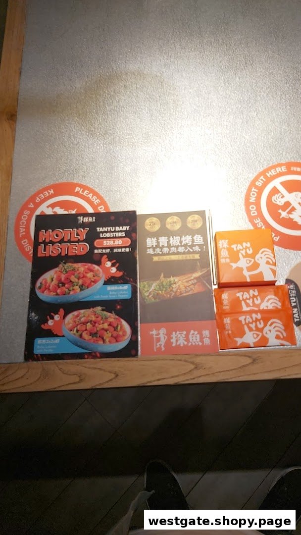 Promotional flyers and branded boxes for TANYU, featuring lobsters and grilled fish.