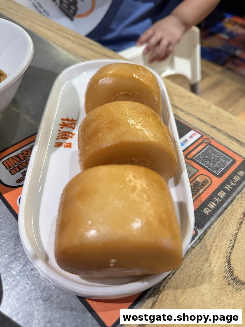 A plate of three golden-brown fried mantou buns, a popular side dish, served on a white rectangular plate.