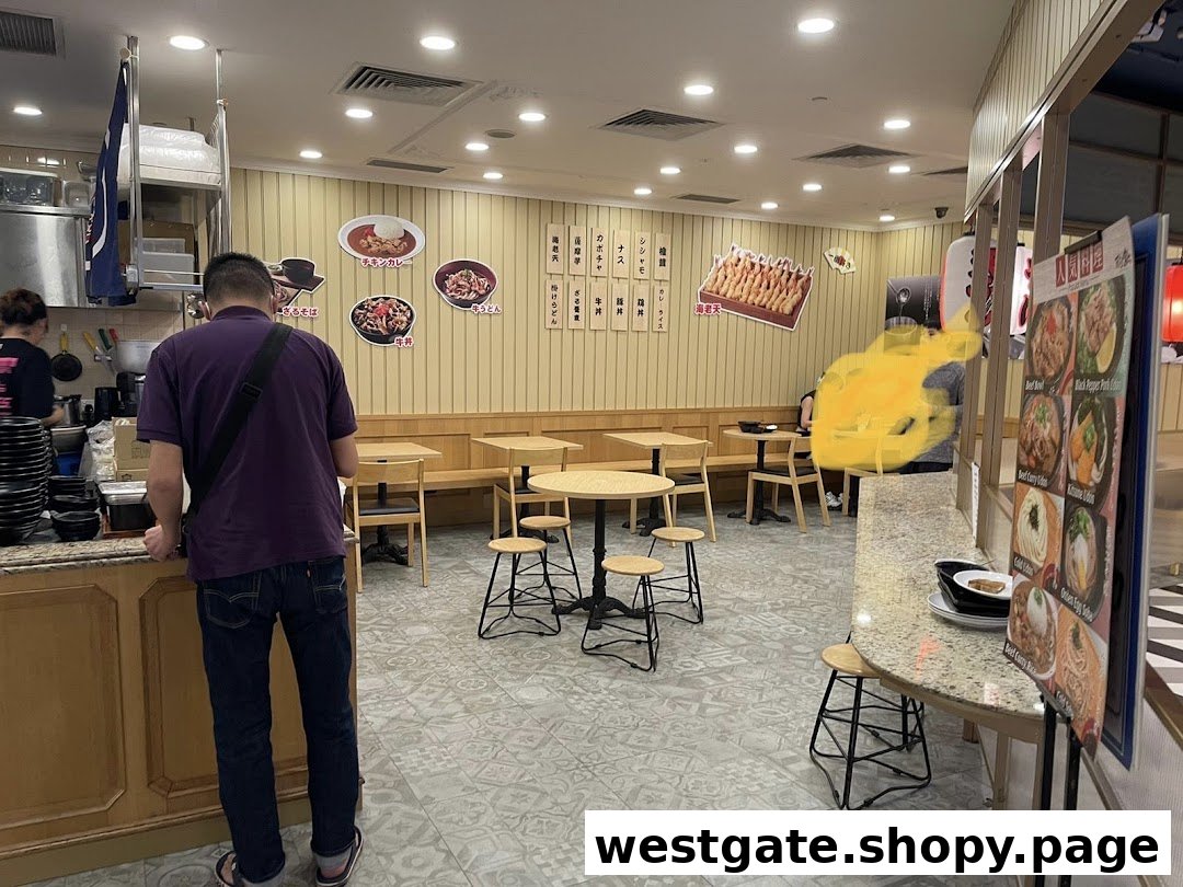 Interior view of Tempura Fuji Westgate, showing dining area, counter, and customers.