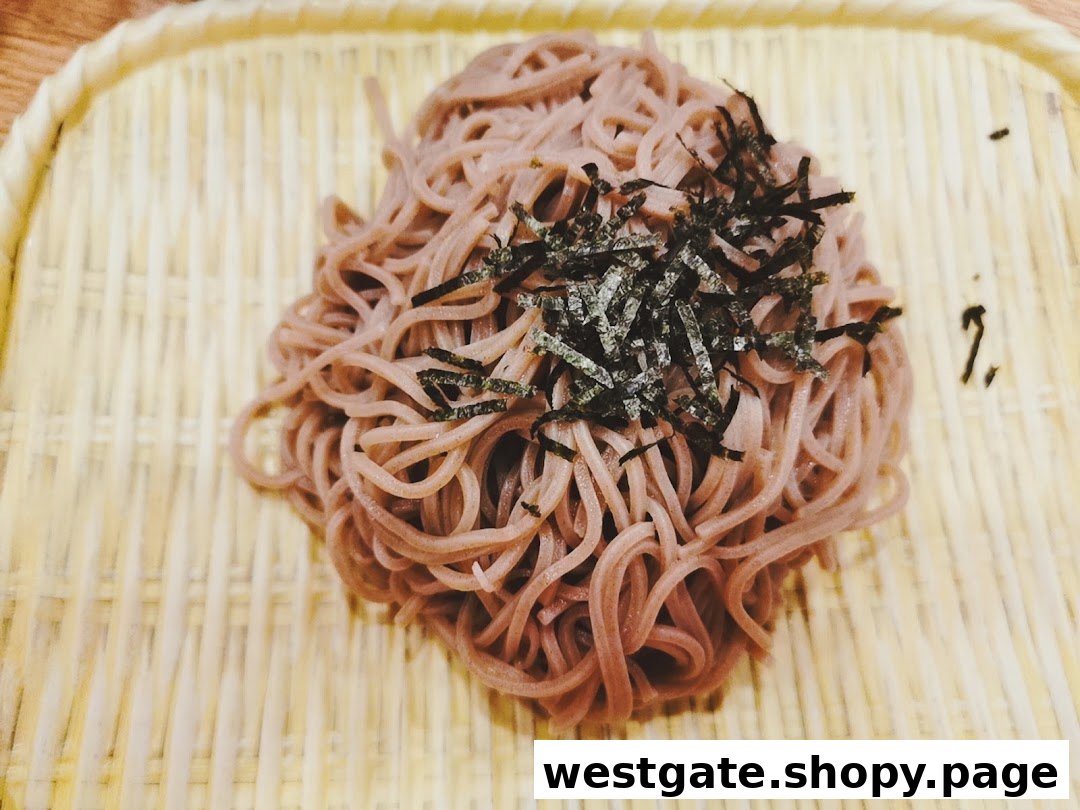A close-up of soba noodles topped with shredded nori, served on a traditional bamboo mat.