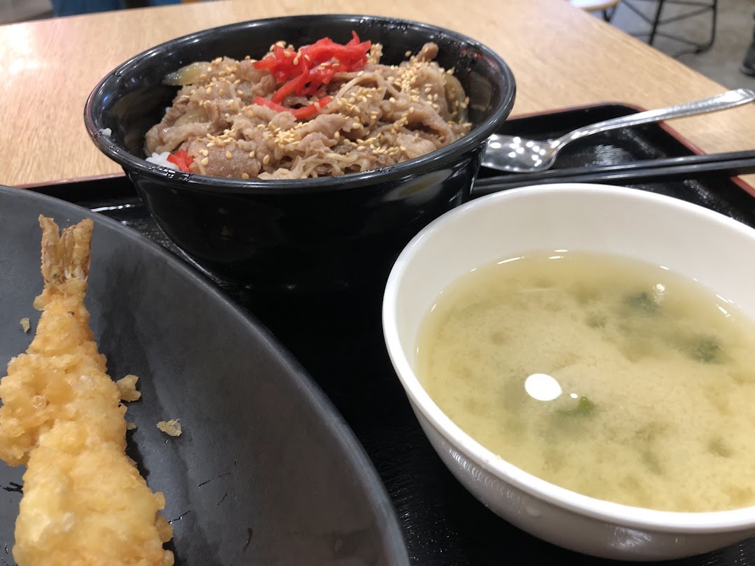 A delicious Japanese meal featuring a beef bowl, crispy tempura, and a comforting bowl of miso soup.
