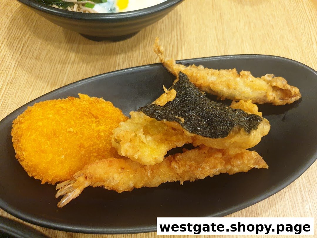 A close-up of a black plate featuring assorted golden-fried tempura, including shrimp, fish, and a croquette.