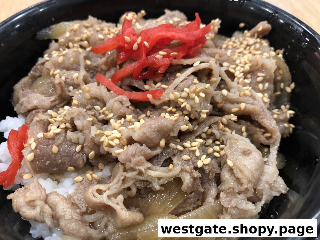 A close-up of a Japanese beef bowl (gyudon) with thinly sliced beef, onions, sesame seeds, and red pickled ginger over rice.