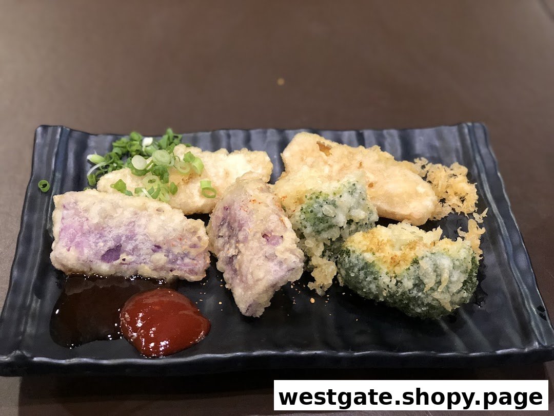 A plate of assorted tempura, including purple sweet potato, fish, and broccoli, served with sauces.