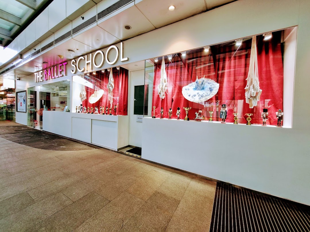 The Ballet School's shopfront features a display window with ballet shoes, tutus, and Nutcracker figures.
