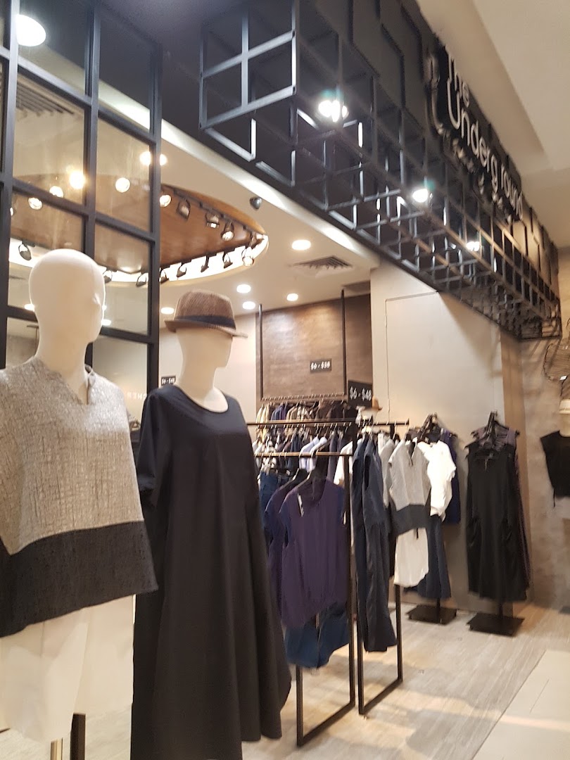 Interior view of The Underground fashion boutique, showcasing modern apparel on mannequins and racks.