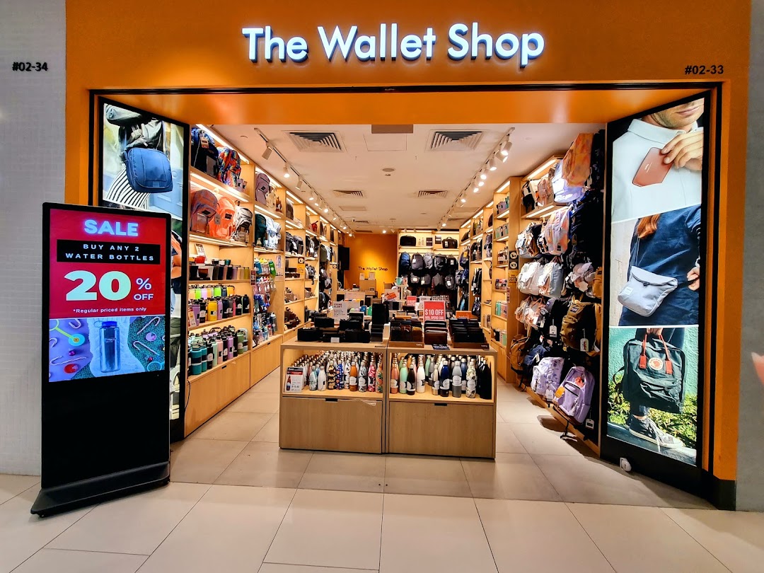 The Wallet Shop storefront showcasing a wide array of wallets, bags, and water bottles, with a sale display.