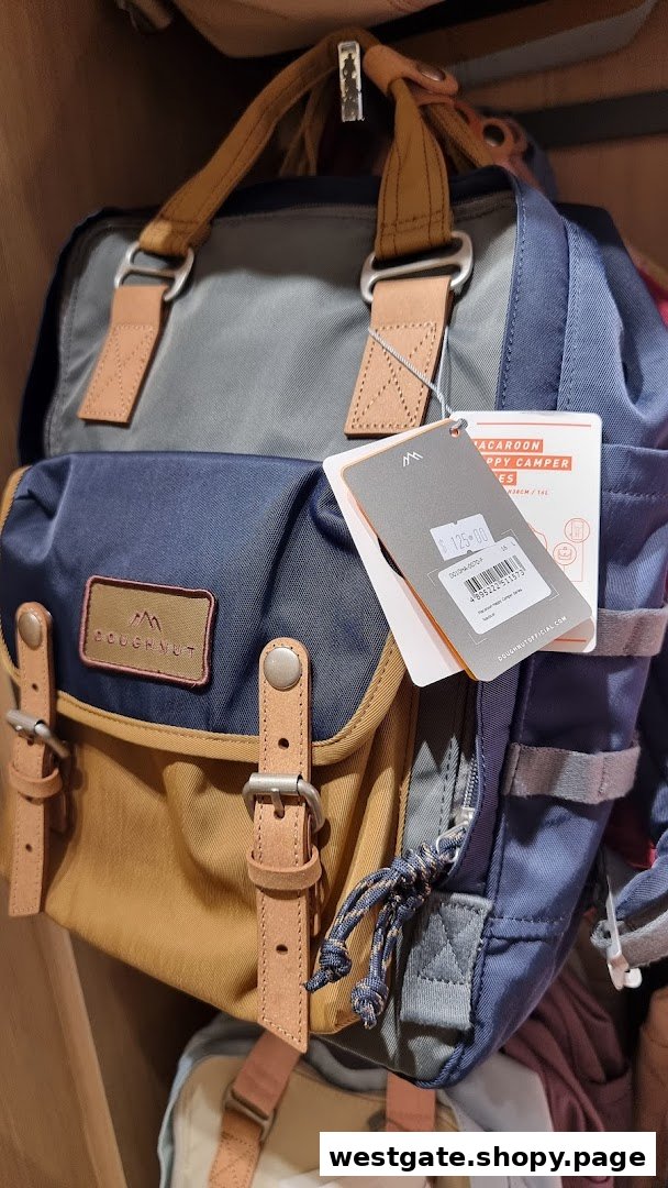 A stylish multi-colored Doughnut brand backpack with a price tag displayed in a retail setting.