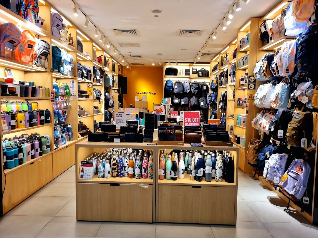 A brightly lit interior of The Wallet Shop, showcasing a wide array of wallets, bags, and stylish water bottles.
