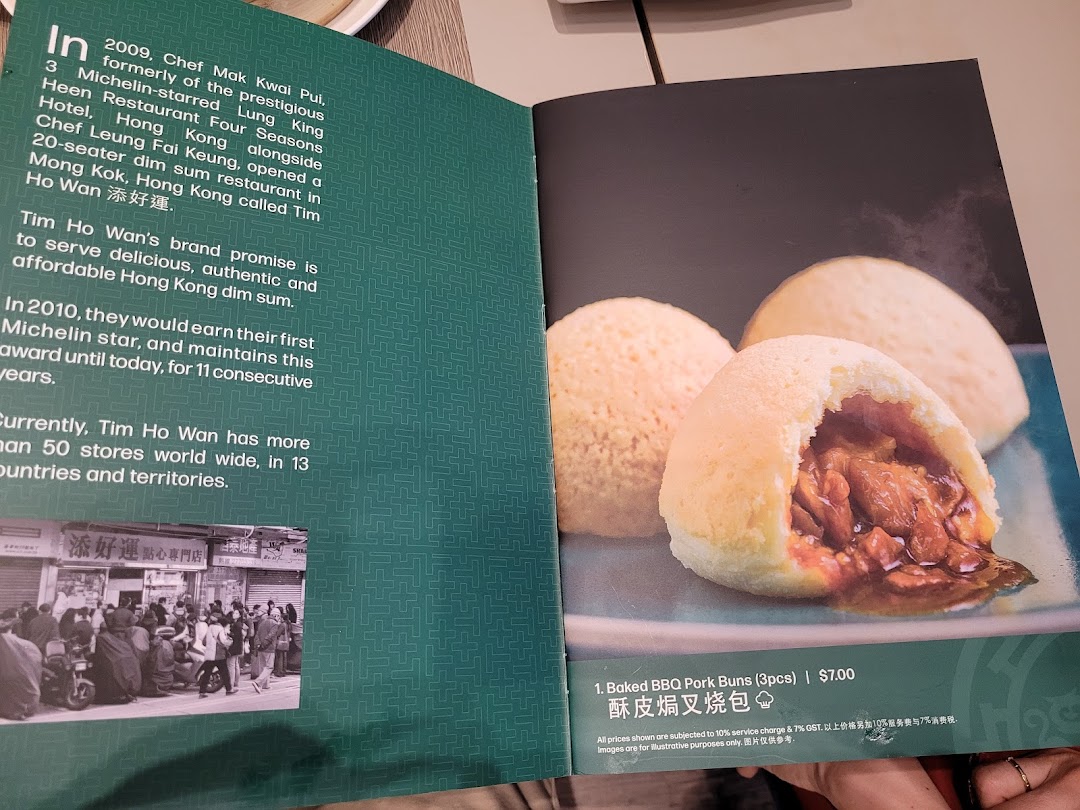 A menu page from Tim Ho Wan featuring Baked BBQ Pork Buns and restaurant history.